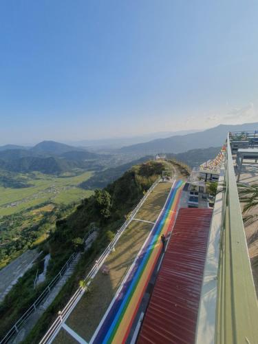 a train with rainbow tracks on the side of a building at Dhikidada Resort in Pokhara