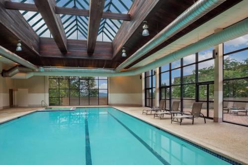 an indoor pool with a glass ceiling and windows at DoubleTree Boston North Shore Danvers in Danvers