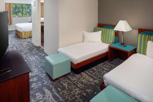 a hotel room with two beds and a tv at DoubleTree Boston North Shore Danvers in Danvers