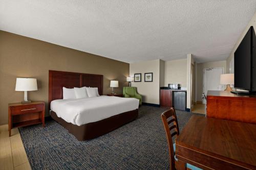 a hotel room with a bed and a television at Comfort Inn On the Ocean in Kill Devil Hills