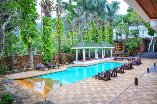 a swimming pool with chairs and a gazebo at Keereeta Resort in Ko Chang