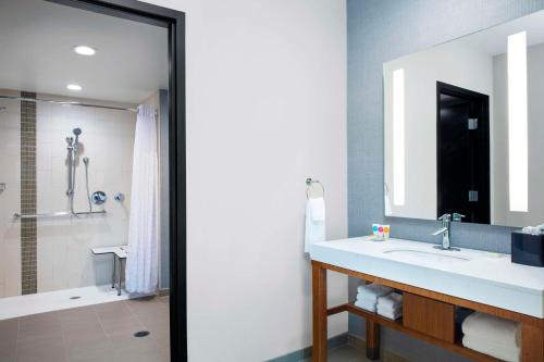 a bathroom with a sink and a shower at Hyatt Place Titusville Kennedy Space Center in Titusville