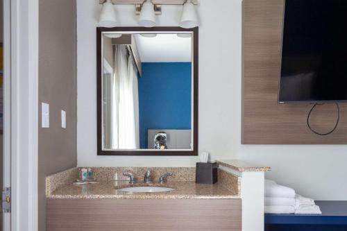 a bathroom with a sink and a mirror at Comfort Suites Medical District near Mall of Louisiana in Baton Rouge