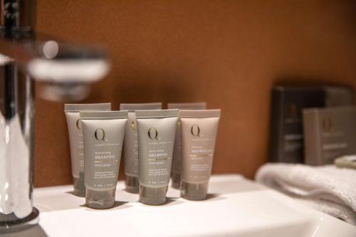 a row of four moisturizers sitting on a counter at Nightelier Mitchelton The Brook in Brisbane