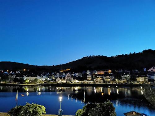 a view of a town on a lake at night at Mosel View Old Town Apartments in Zell an der Mosel