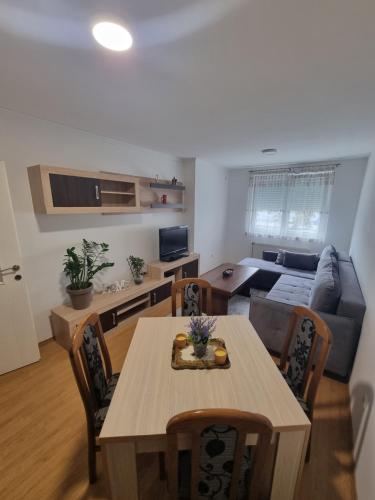 a living room with a table and a couch at CityLux Doboj in Doboj