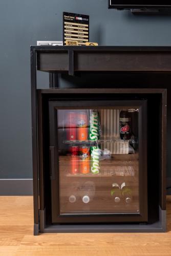 a small refrigerator with drinks inside of it at İbos Hotels Izmir in Izmir