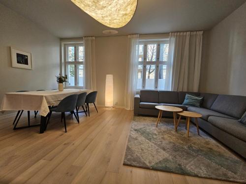 a living room with a couch and a table at Apartment with Balcony in Erling Skjalgssons in Oslo