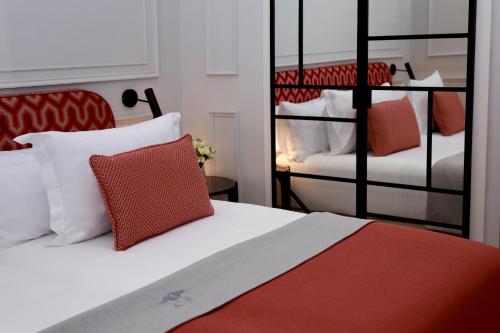 a bedroom with two bunk beds with red and white pillows at Hotel Boutique Casa Romana Villa in Seville