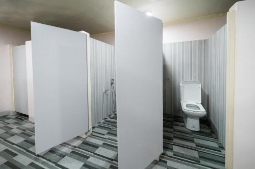 a bathroom with a toilet in a stall at Freedom Eco Adventure Park powered by Cocotel in Boac