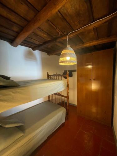 1 Schlafzimmer mit 2 Etagenbetten und einer Beleuchtungseinrichtung in der Unterkunft Casa Félix in Linares de la Sierra