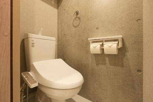 a bathroom with a toilet and two rolls of toilet paper at Seirai Asakusa Vacation Rental - 3 minutes from station in Tokyo