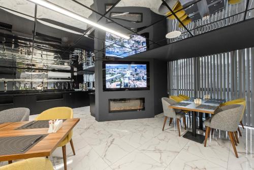 a dining room with a fireplace and a tv at İbos Hotels Izmir in Izmir