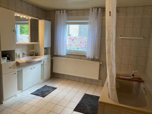 y baño con bañera y lavamanos. en Gästehaus Trockau, en Pegnitz