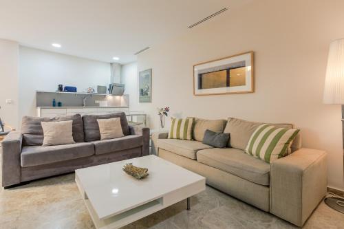 a living room with two couches and a coffee table at Green-Apartments Alto de Santa Cruz in Seville