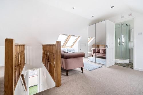 a living room with a chair and a mirror at Sandy Feet Retreat in South Hayling