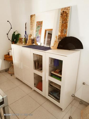 a white kitchen cabinet with a counter top at Casapatrizia Appartamento compartido in Santa Cruz de Tenerife