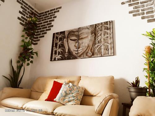 a living room with a couch and a picture on the wall at Casapatrizia Appartamento compartido in Santa Cruz de Tenerife