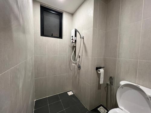 a bathroom with a shower with a toilet and a television at Cozy Studio Boulevard2 @ Kajang Town / 25-10 in Kajang