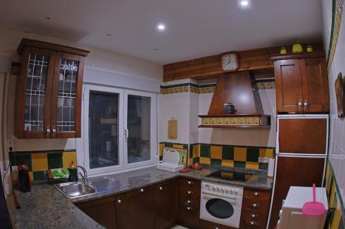 a kitchen with a sink and a dishwasher at Casa el Cerezo Rojo in El Rasillo