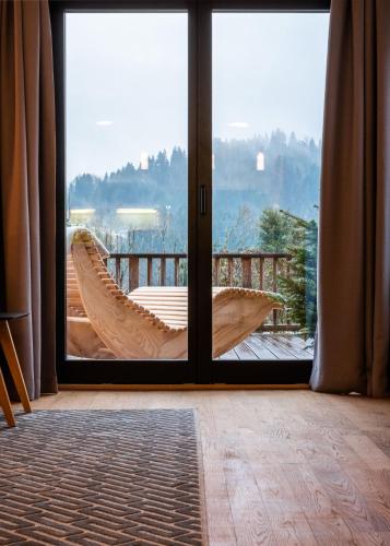 a sliding glass door with a hammock on a balcony at KaiserMoments in Going