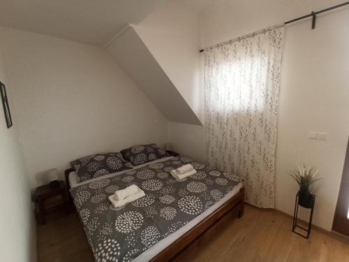 a bedroom with a bed with two towels on it at Apartmán Vendelínka in Valtice