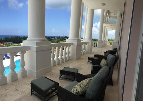 a balcony with chairs and a view of the water at Ocean West Boutique Hotel in Nassau