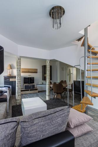 a living room with a couch and a table at Voyage Pension in Leipzig