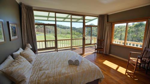 a bedroom with a bed with two slippers on it at Southern Ocean Retreats - Deep Creek National Park in Delamere