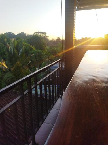 a balcony of a house with a view of the ocean at Wahwik's House in Ubud