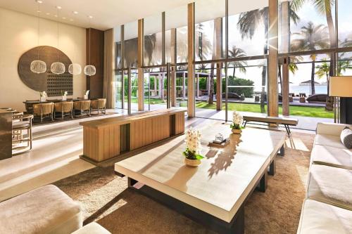 a living room with a table and some chairs at The Ritz-Carlton Maldives, Fari Islands in North Male Atoll