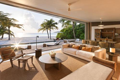 a living room with a view of the ocean at The Ritz-Carlton Maldives, Fari Islands in North Male Atoll