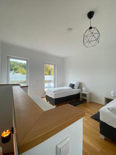 a white room with a bed and a couch at Modern Living Regensburg in Regensburg
