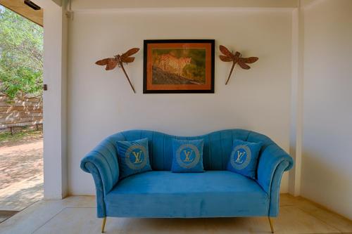a blue couch in a living room with a picture at O2 Villas Yala in Yala