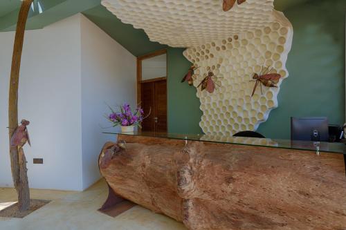 a bar with a large wooden stump in a room at O2 Villas Yala in Yala