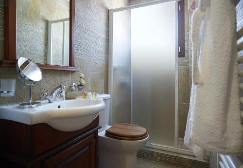 a bathroom with a toilet and a sink and a shower at Villa Haraki Paradise in Haraki