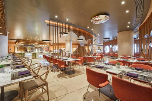 a restaurant with tables and chairs in a room at The Westin Shenzhen Nanshan in Shenzhen