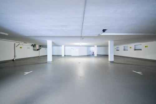 an empty parking garage with white walls and ceilings at Auerhahn Feldberg in Feldberg