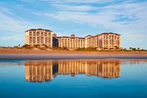 a hotel on the beach with its reflection in the water at The Ritz-Carlton, Amelia Island in Fernandina Beach