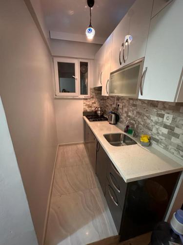 a kitchen with a sink and a counter top at Bomontide metroya çok yakın şirin daire in Istanbul