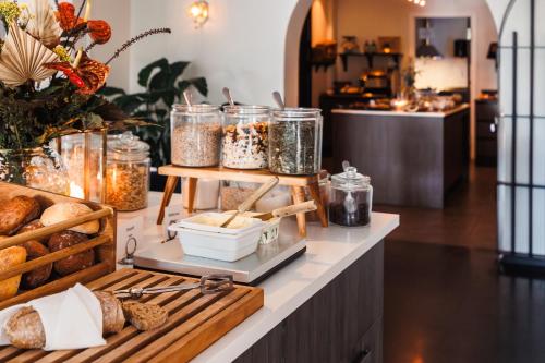 a bakery counter with bread and jars of food at Piteå Stadshotell in Piteå