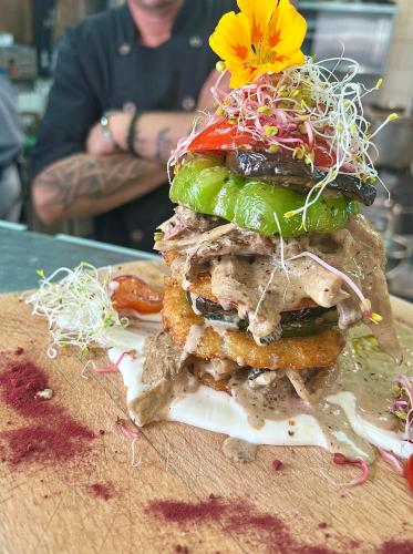a large sandwich with a flower on top of it at Apartamenty Mesa Grill Restaurant Cafe in Dźwirzyno