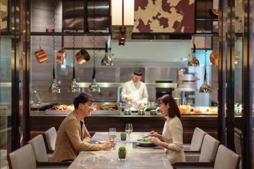 two people sitting at a table in a restaurant at JW Marriott Hotel Yinchuan in Yinchuan