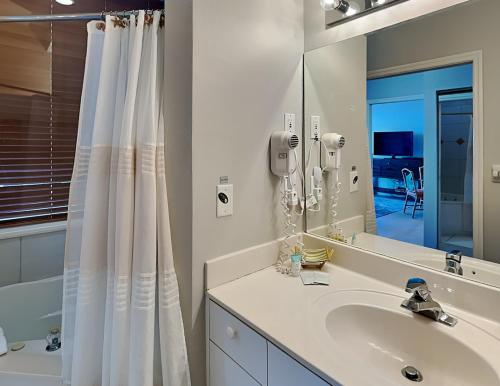 a bathroom with a sink and a mirror at Lovers Key Resort Penthouse 3 in Fort Myers Beach