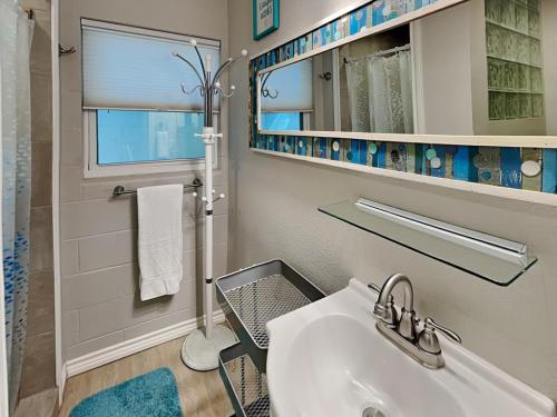 a bathroom with a sink and a shower and a mirror at Harbor Lights Cottages 3 in Rockport