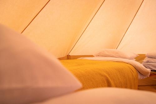a room with two beds in a tent at Avalon Boutique Camping @ The Crossways in North Wootton