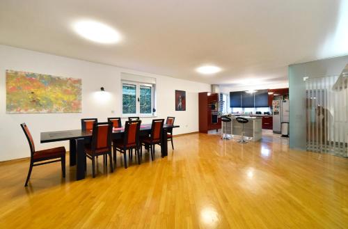 a dining room and kitchen with a table and chairs at GreenHouse in Zagreb