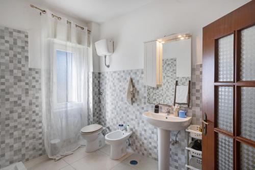 a bathroom with a sink and a toilet and a shower at Casa Martina in Giugliano in Campania