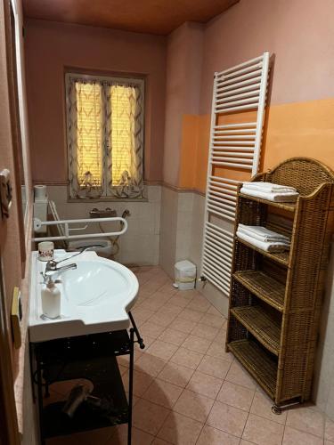 a bathroom with a sink and a towel rack at B&B Il Rifugio in Bastia Umbra