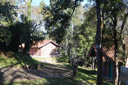 a house in the middle of a road with trees at Pousada da Chacara in Nova Petrópolis